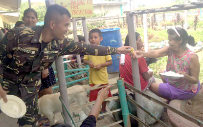 <p><strong>HELPING HAND.</strong> A 79<sup>th</sup> Battalion soldier distributes canned food to residents displaced following an encounter between government troops and rebels in San Carlos City, Negros Occidental earlier this week. <em>(Photo courtesy of 3rd Division Public Affairs Office )</em></p>
<p> </p>